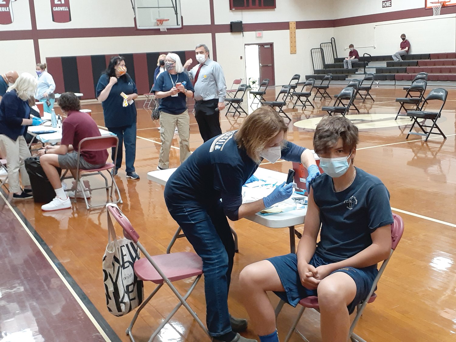 Pictured, Matt Chofay from Monsignor Clarke gets his first shot of the Pfizer vaccine.